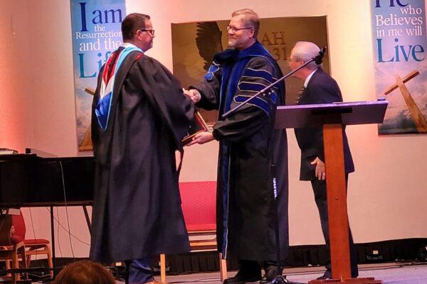 Dr. Best receiving his honorary Doctorate of Divinity